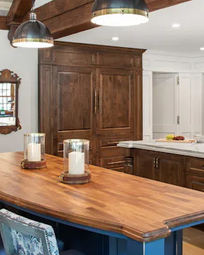 butcher block top, paneled refrigerator, two pendant lights