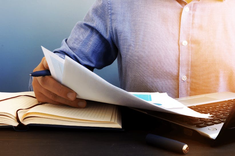 A picture of a man holding a report