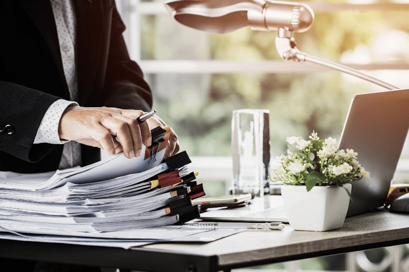 A picture of a man searching through the documents