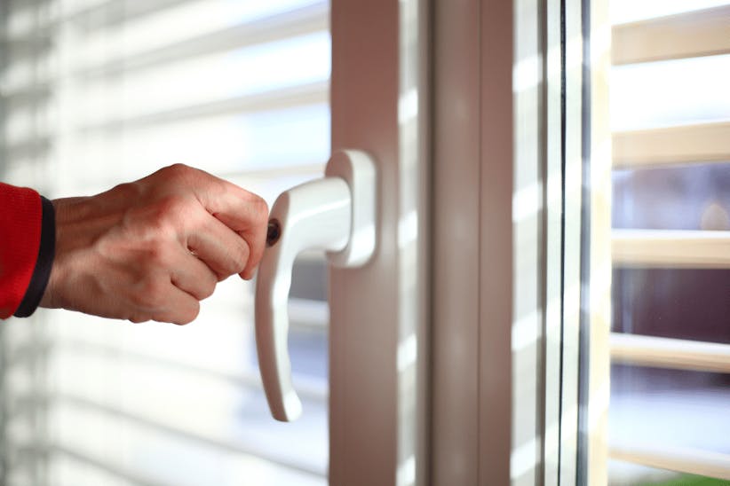 A picture of an arm locking a window