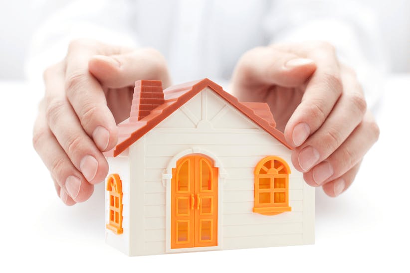 An arms covering a house