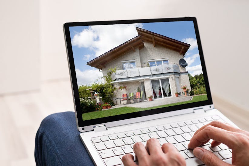 person browsing a property on a laptop