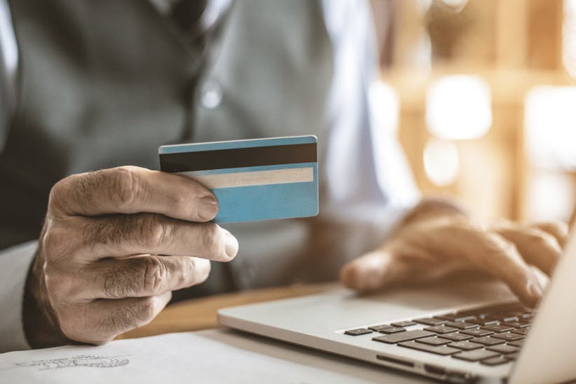 A picture of a person holding a credit card