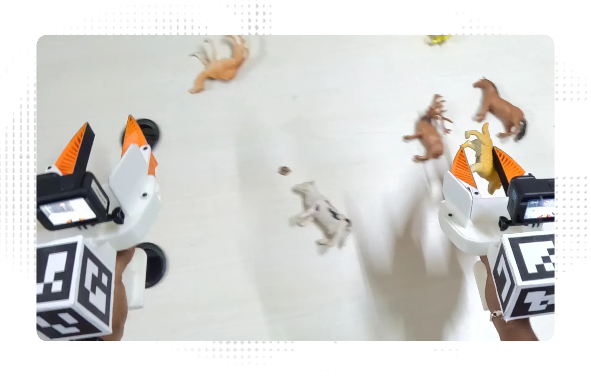 UMI grippers grabbing plastic animals on table