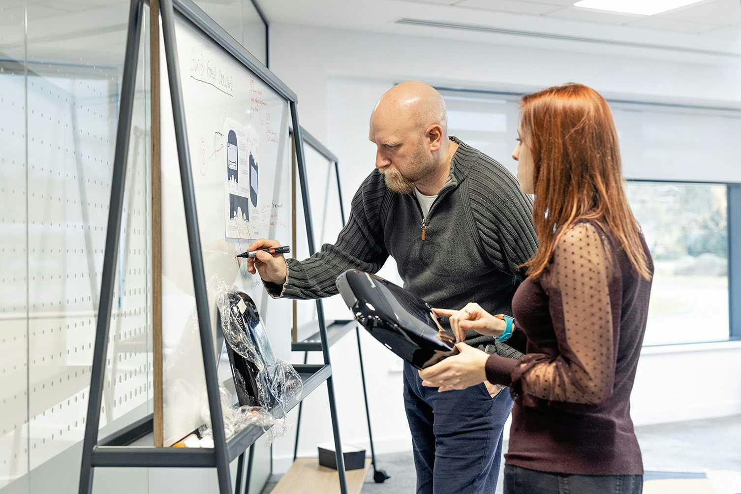 Endomag staff working through product design on a whiteboard 