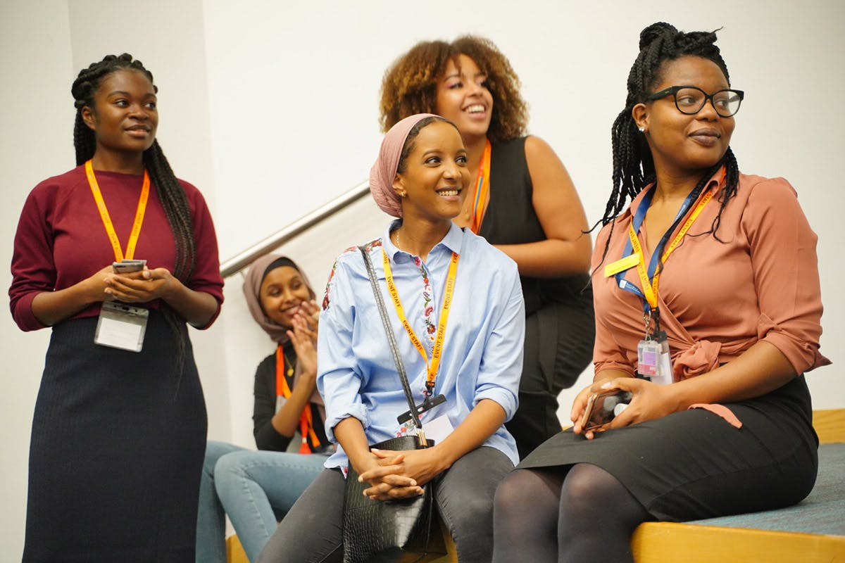 Black Women and Breast Cancer attendees looking engaged in activities out of shot