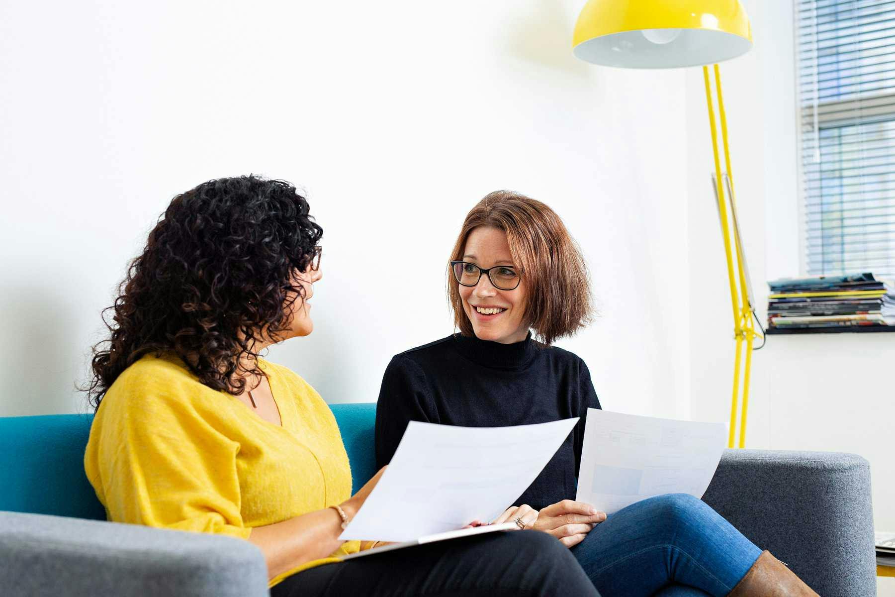 Two female Endomag employees sat on sofa
