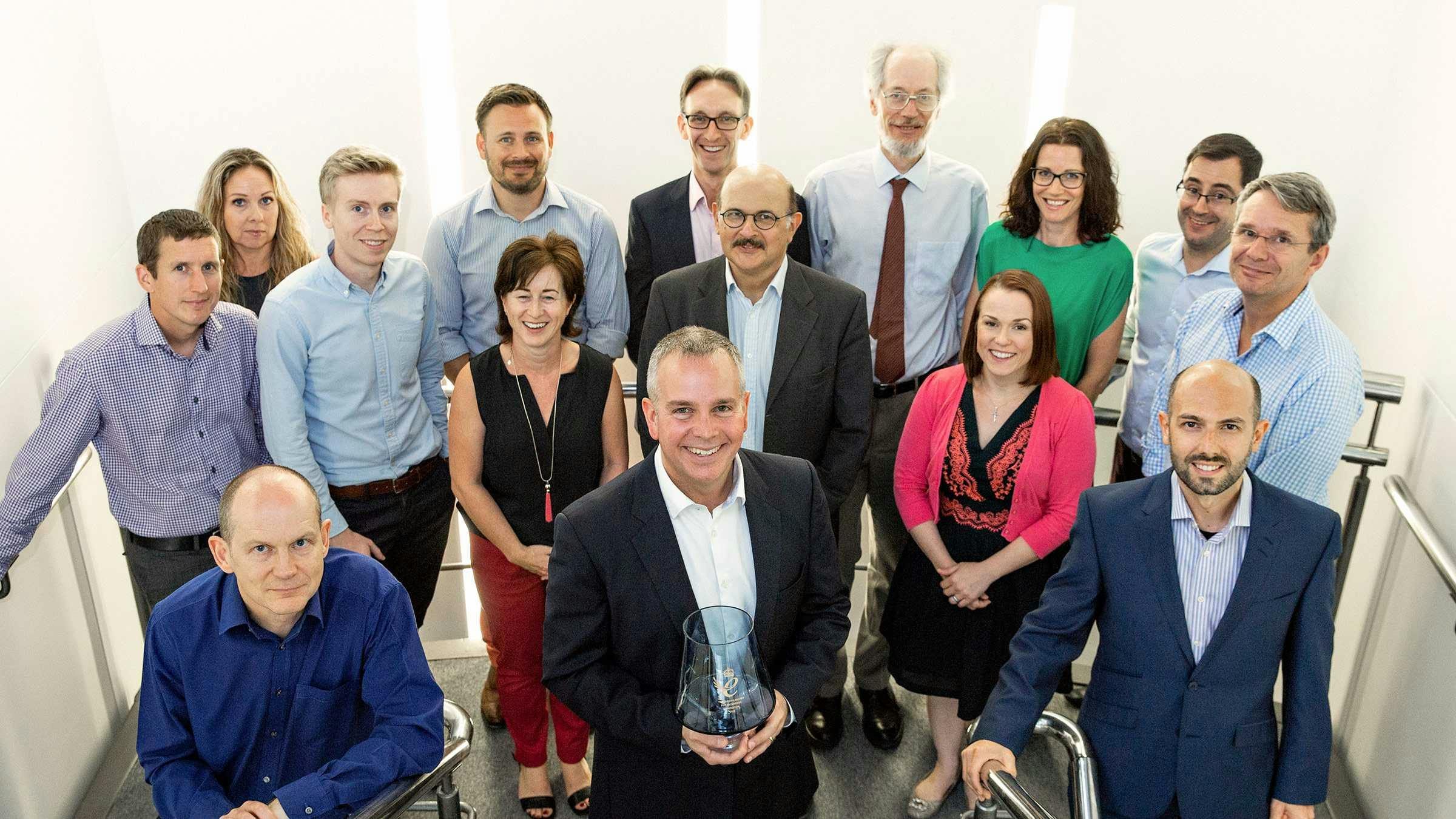 Endomag staff gathered round with the Queen's Award prize 