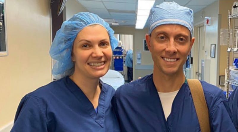 Dr Peled and her husband in surgical scrubs 