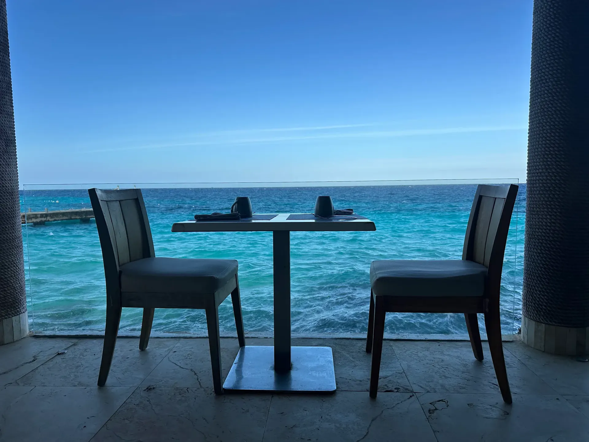 breakfast in Cozumel two chairs and a table with an ocean view