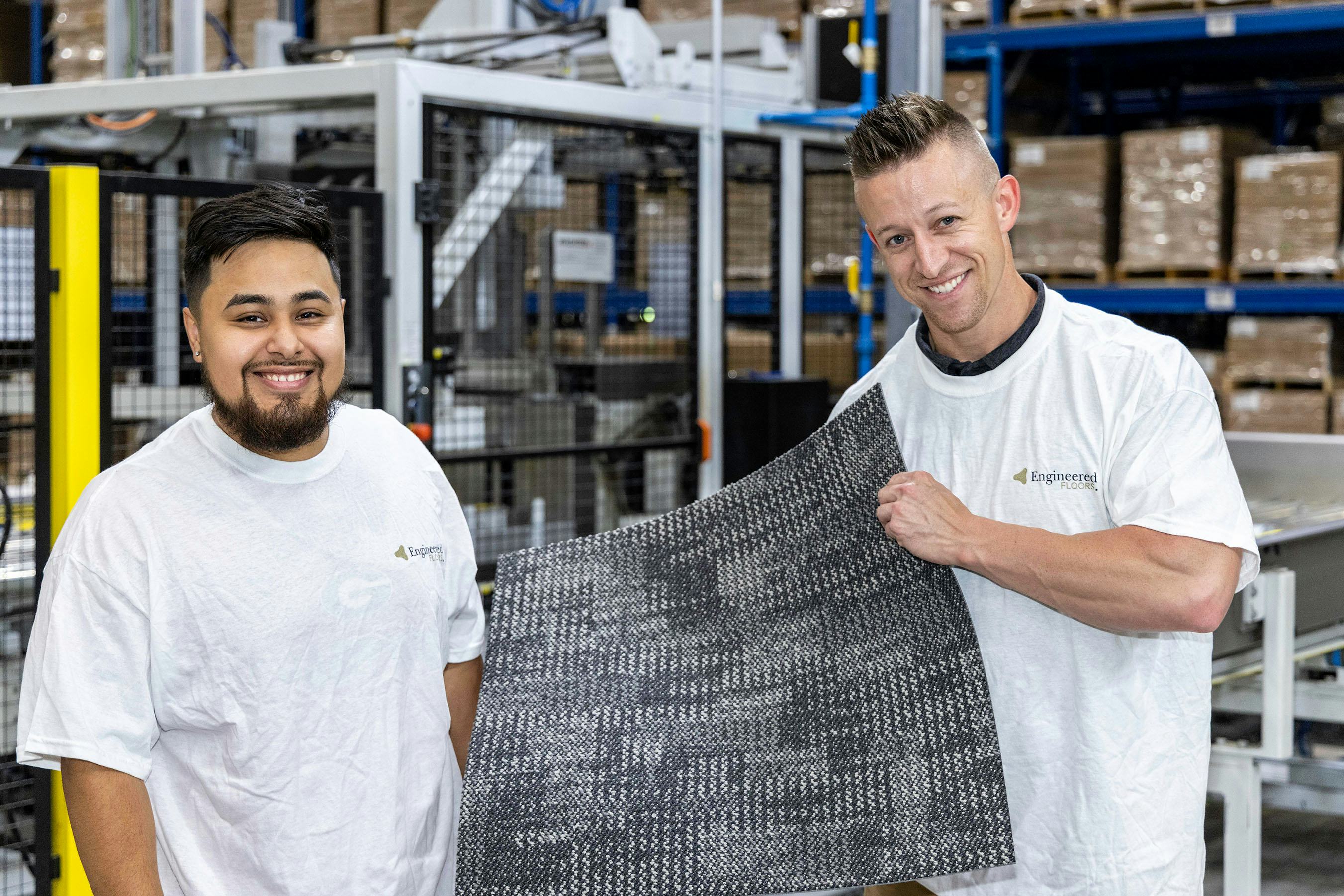 EF employees holding carpet tile