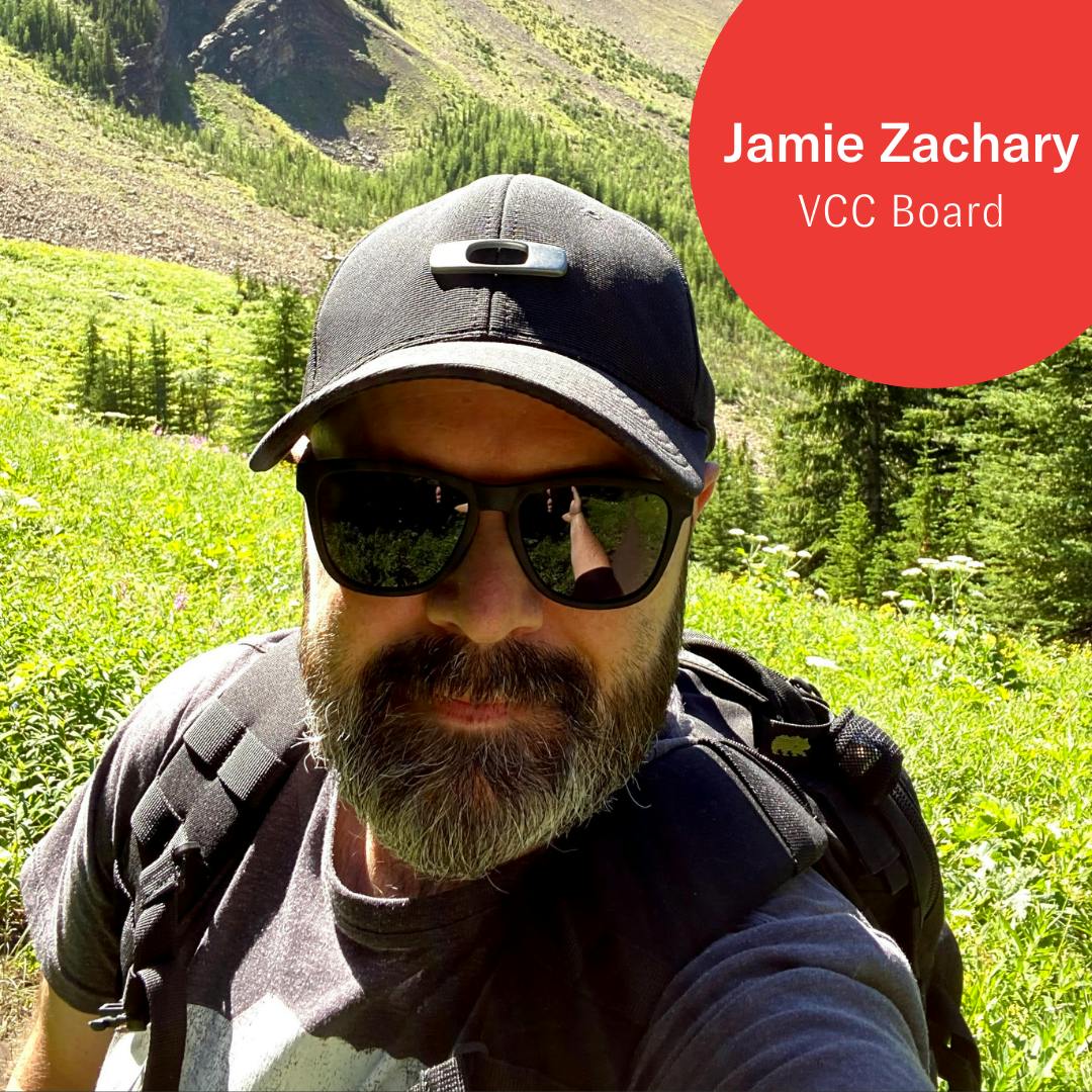 PIcture of Jamie outdoors with green grass in the background.