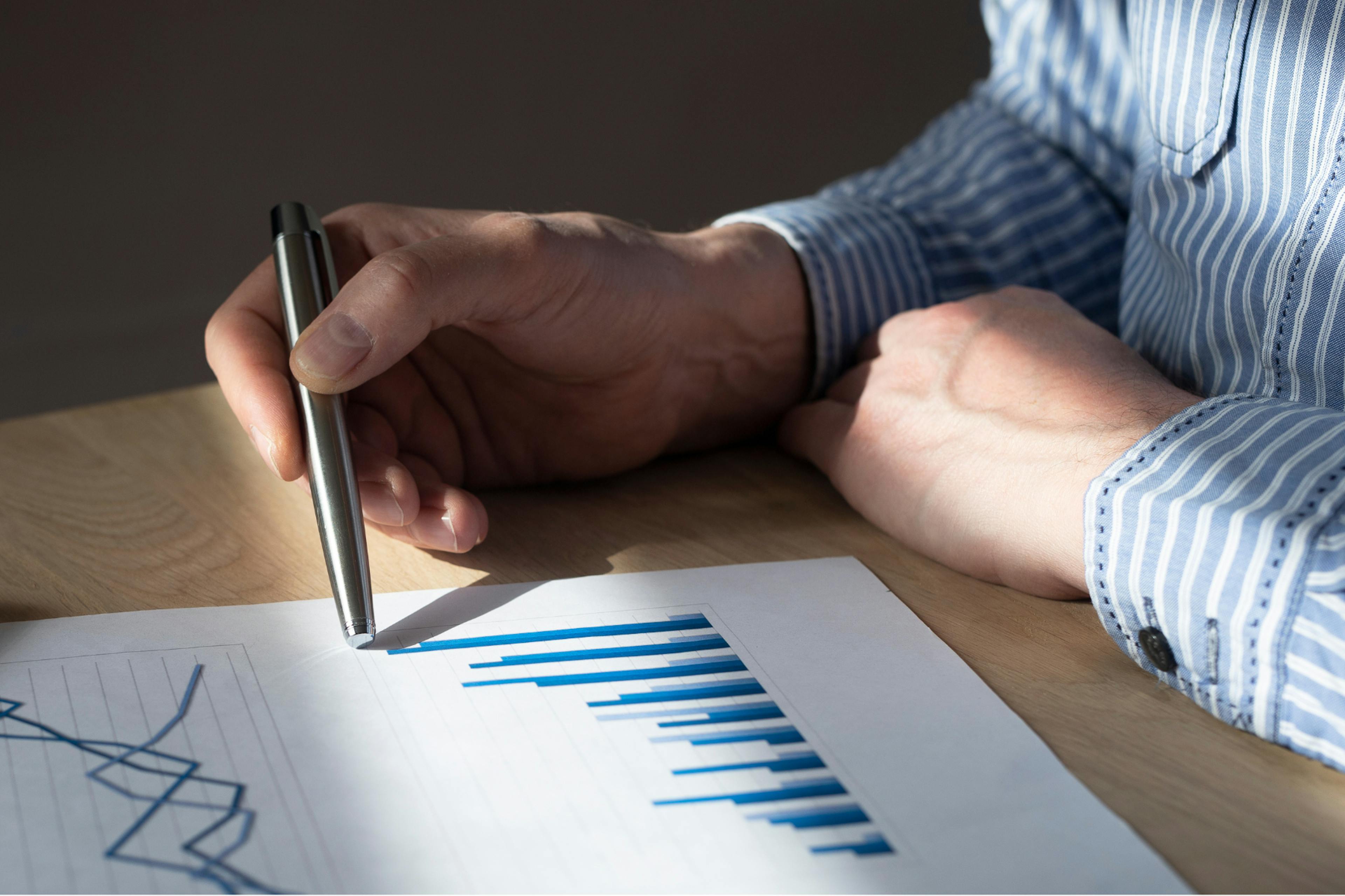 Person looking at graphs on a piece of paper