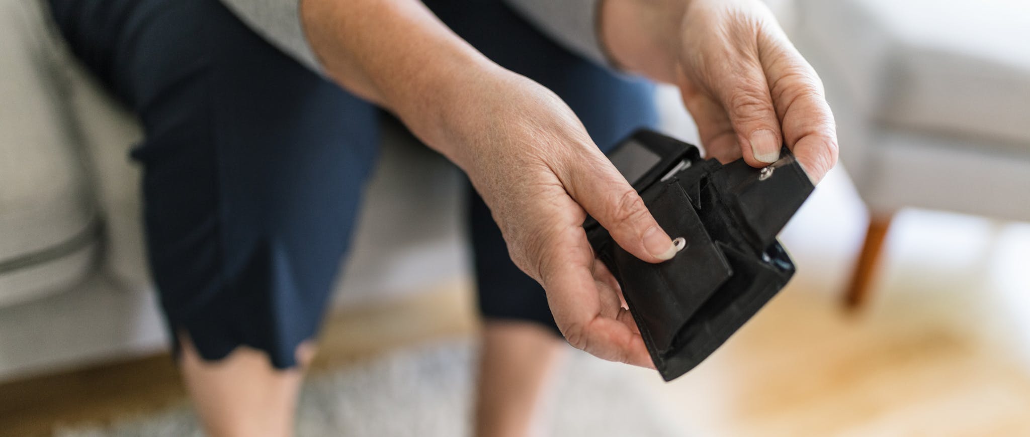 hands holding an empty black wallet