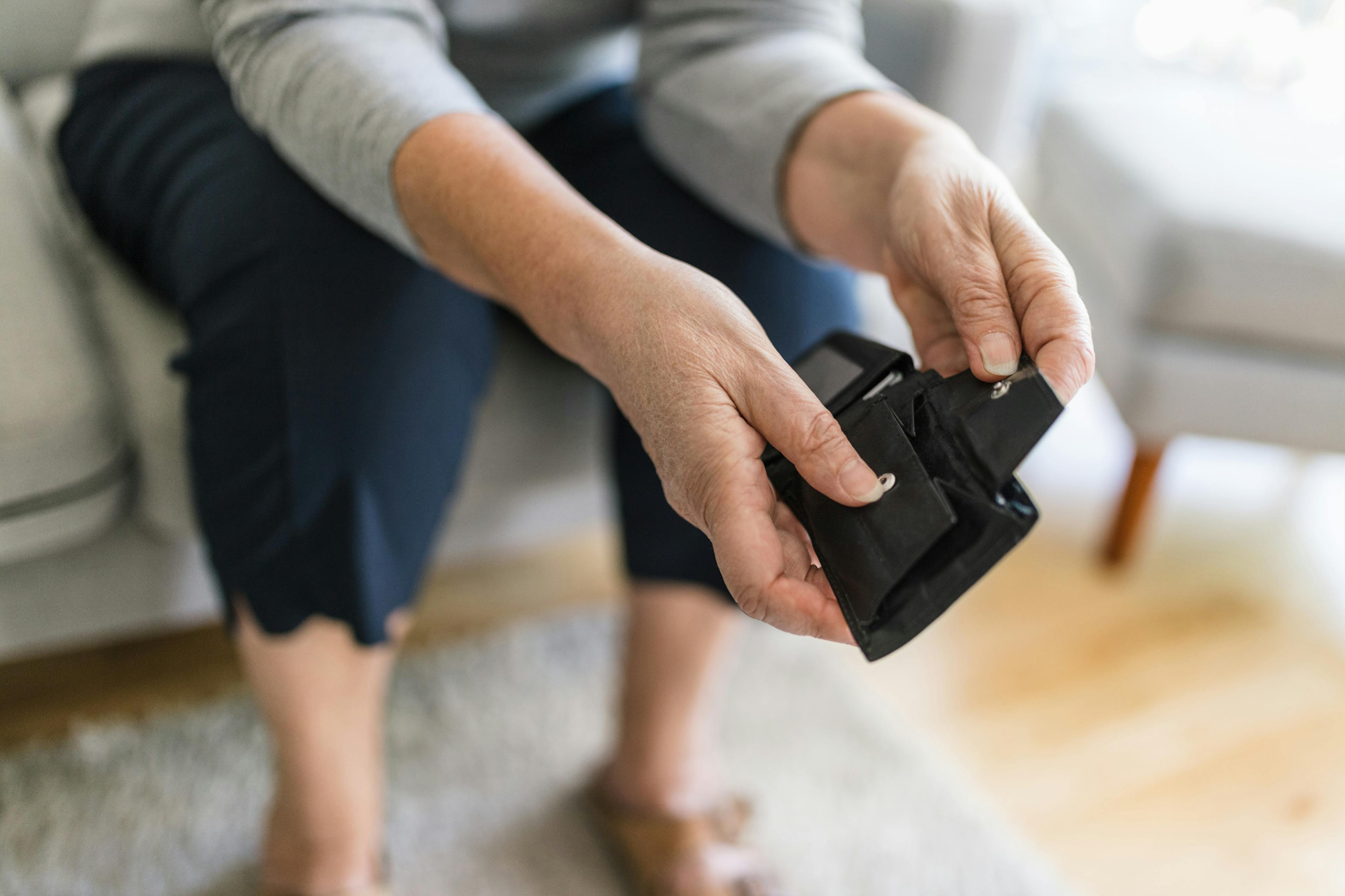 hands holding an empty black wallet