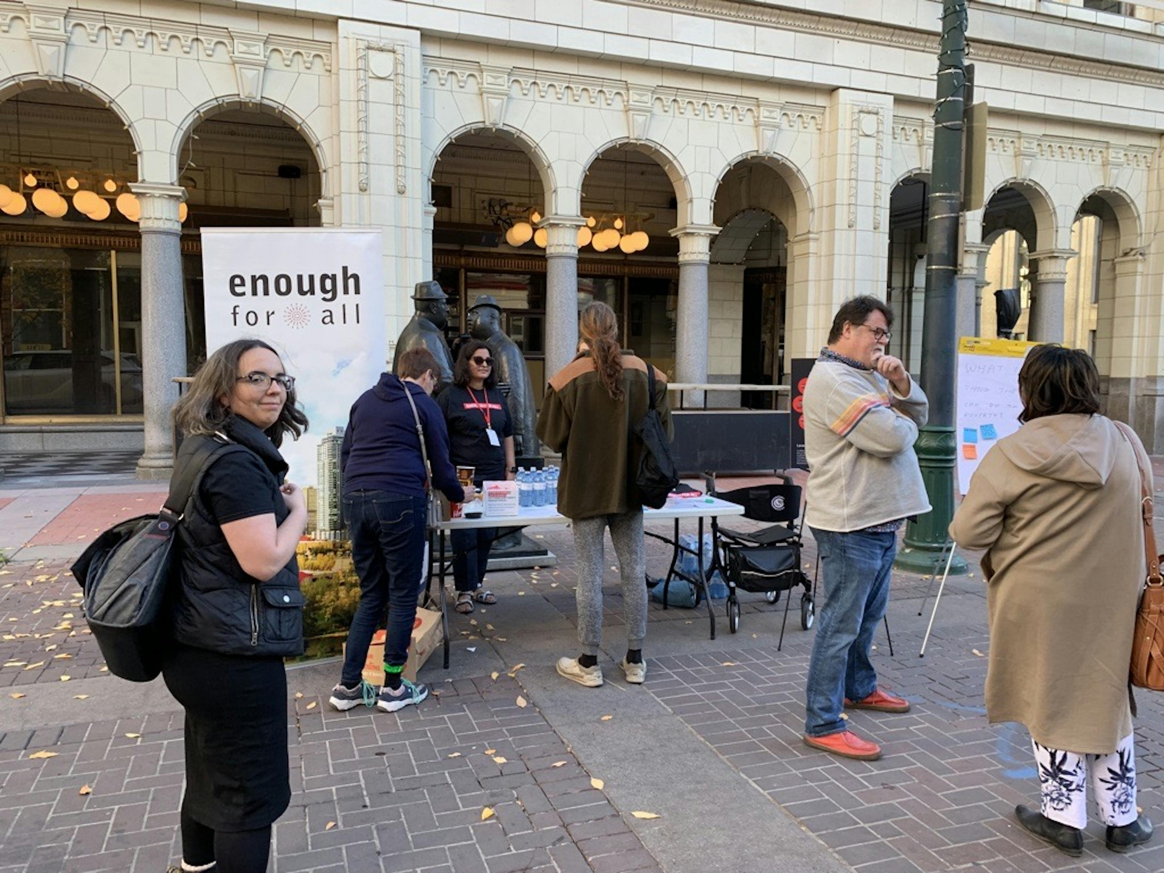 Enough for All staff at a table on Stephen Avenue Mall on the International Day for the Eradication of Poverty