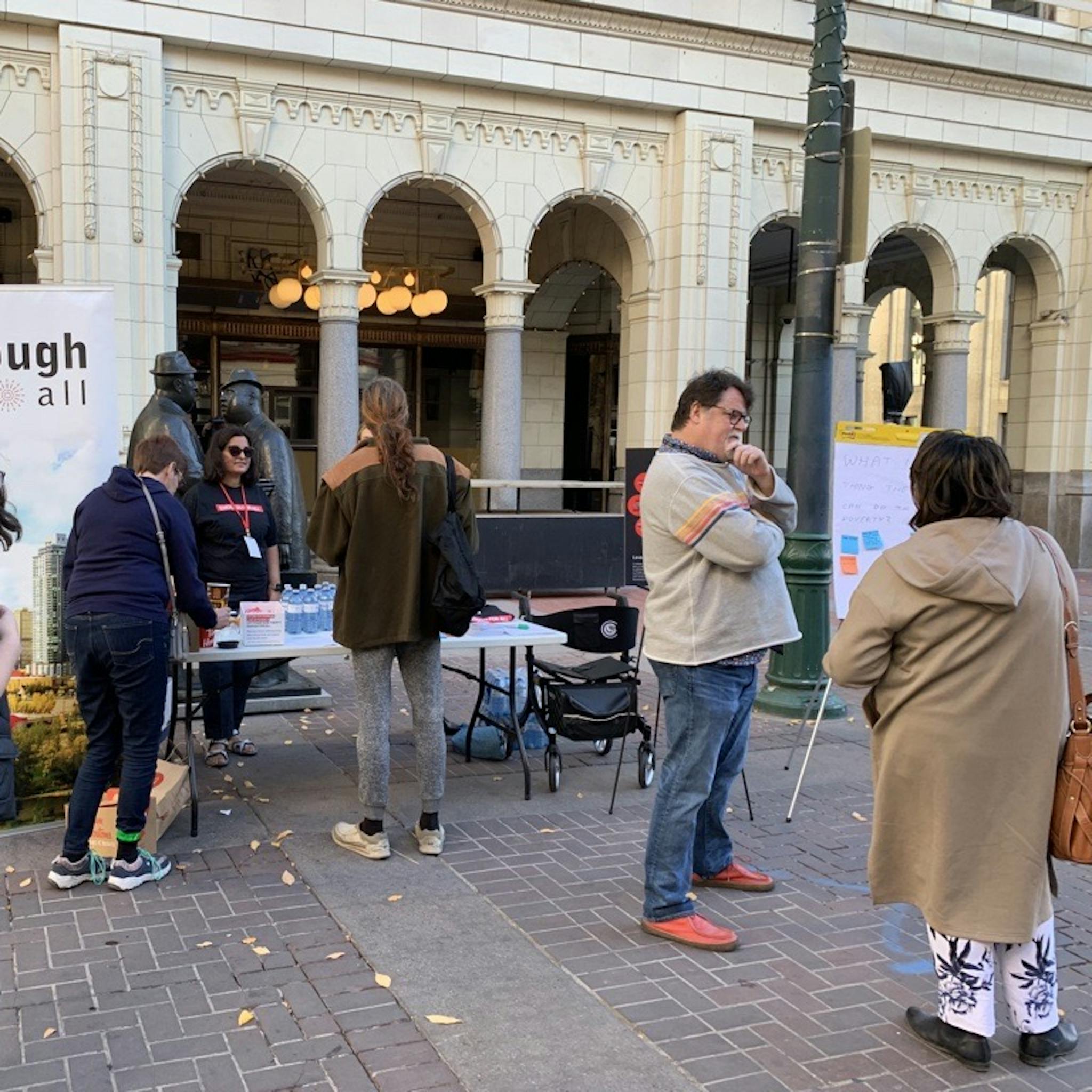 An image of a group of people networking on the street.