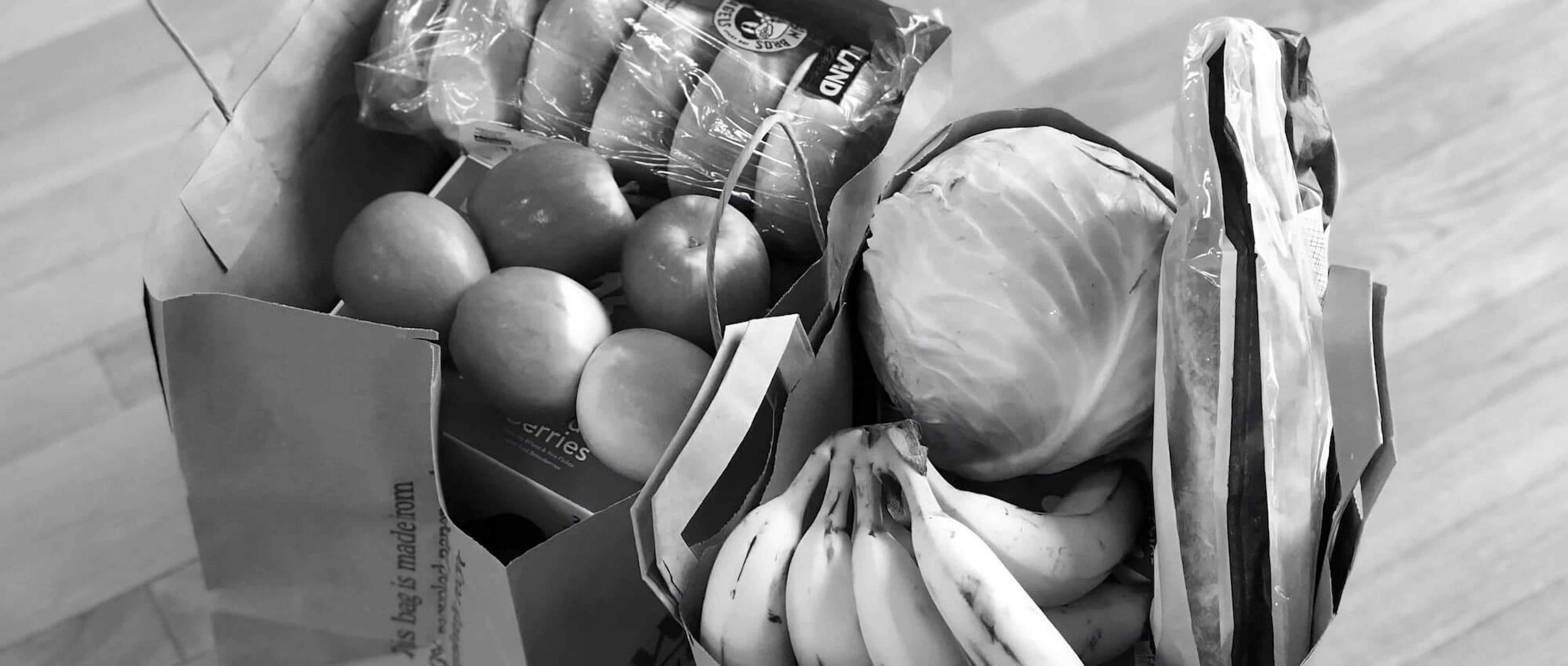Two bags of fresh groceries, in black and white