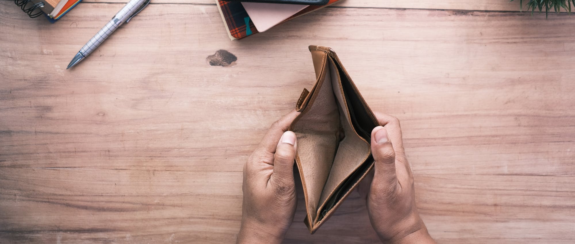 Women's hands opening an empty wallet