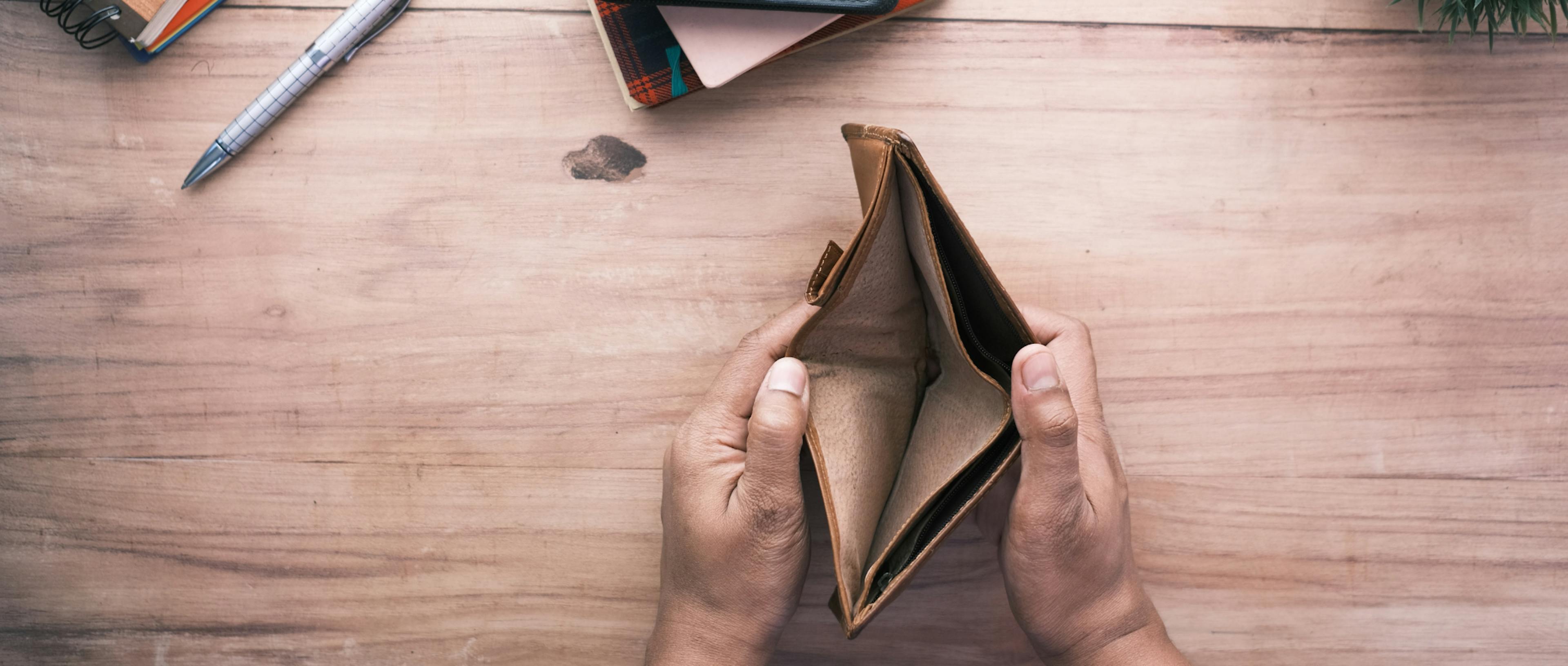 Women's hands opening an empty wallet