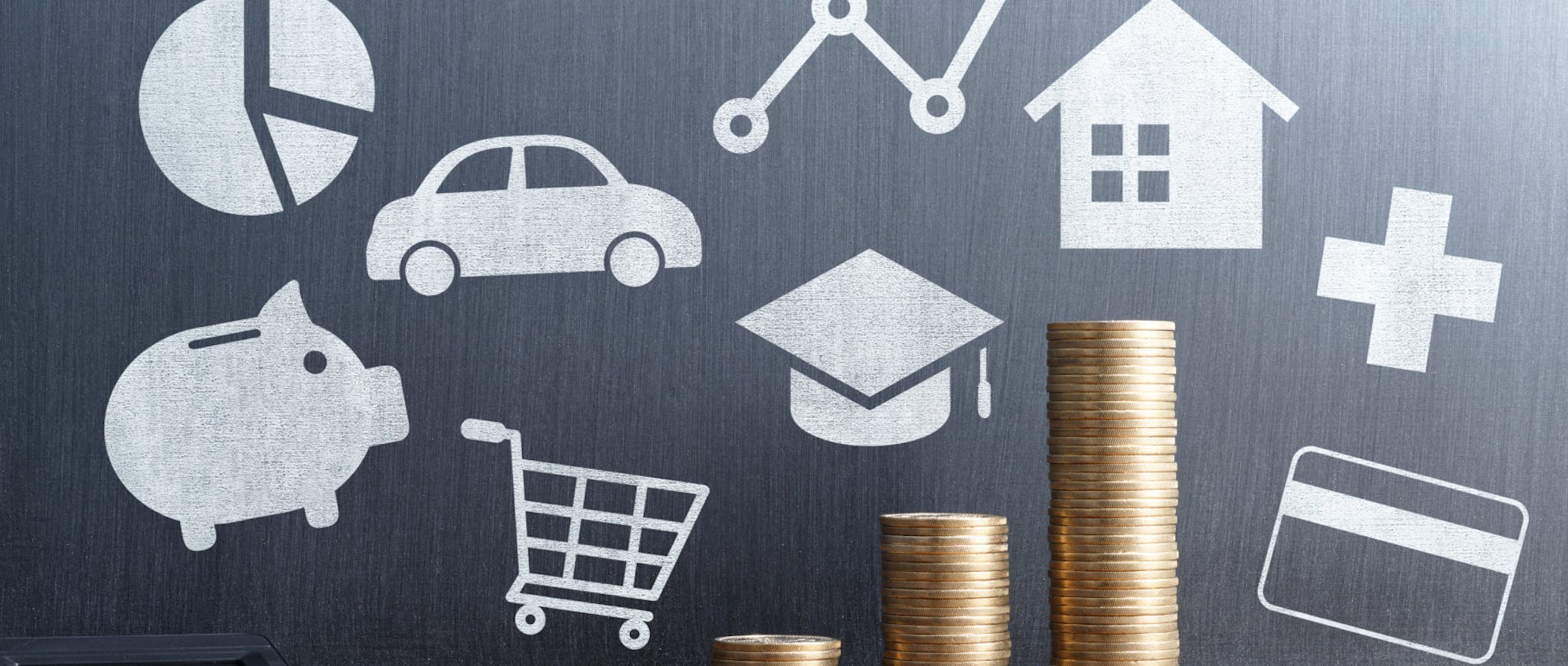 Stacked coins increasing with chalk drawn icons in the background for housing, savings, education and groceries. 