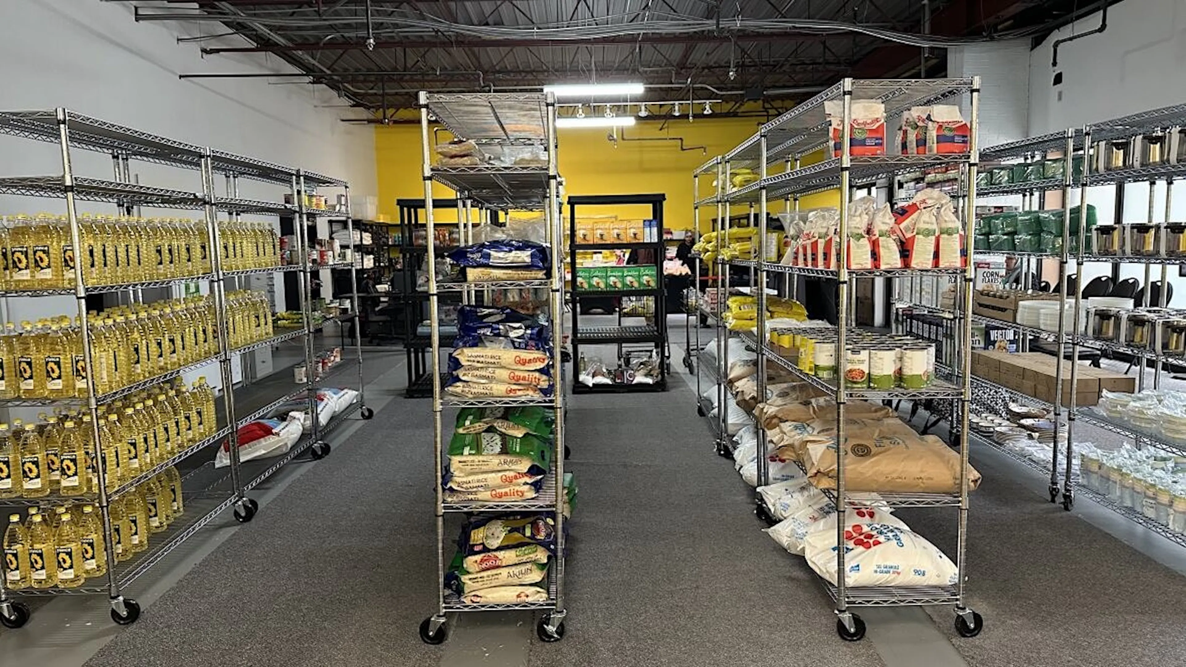The pantry at a back of grocery store, with shelves stacked high with various food.