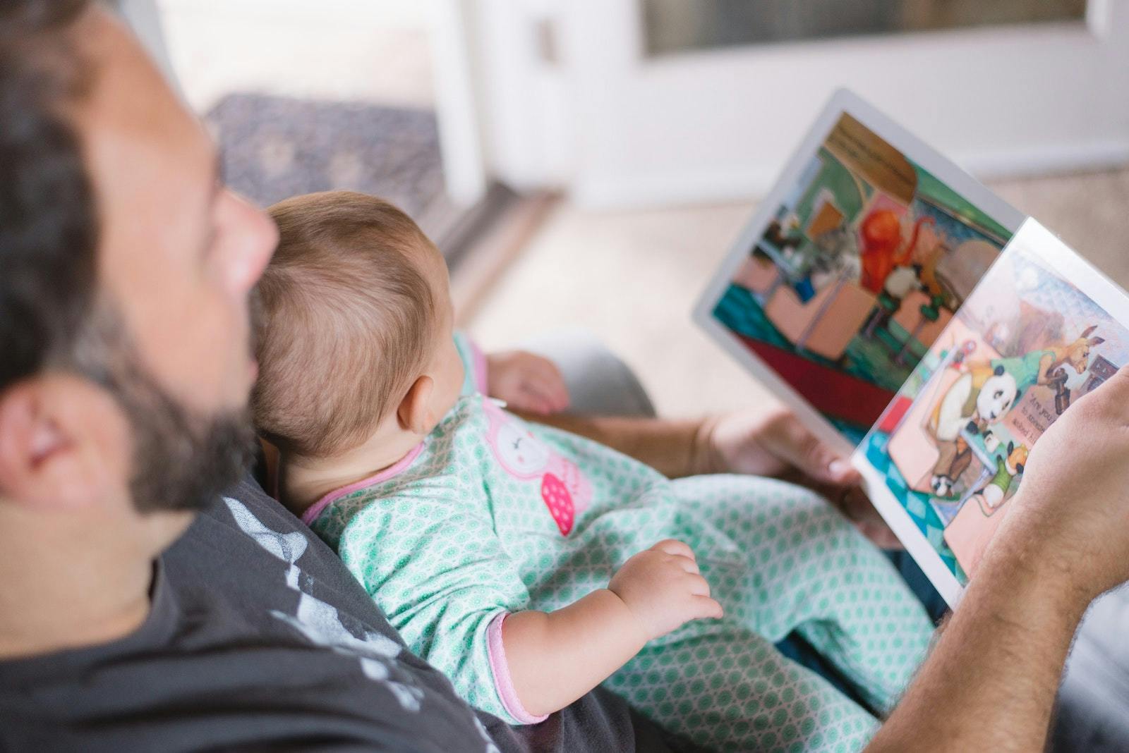 A father reading to his baby