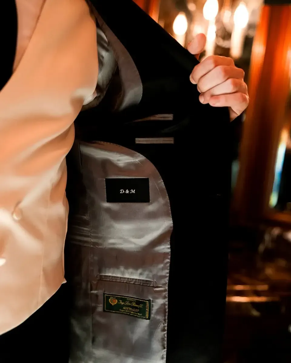 Monogrammed interior of a full-canvas Enzo Custom wedding jacket, evening light