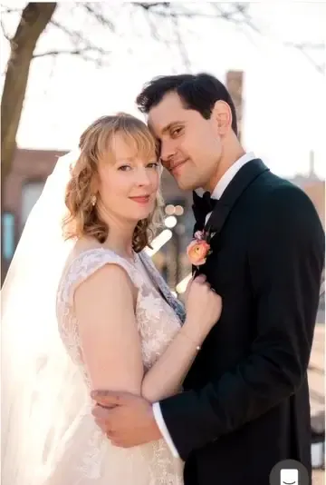 Ryan and Caroline embracing outside in winter