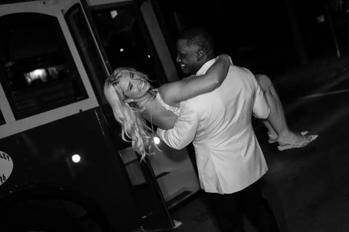 Jeremy sweeping Mikaela off her feet at the wedding reception