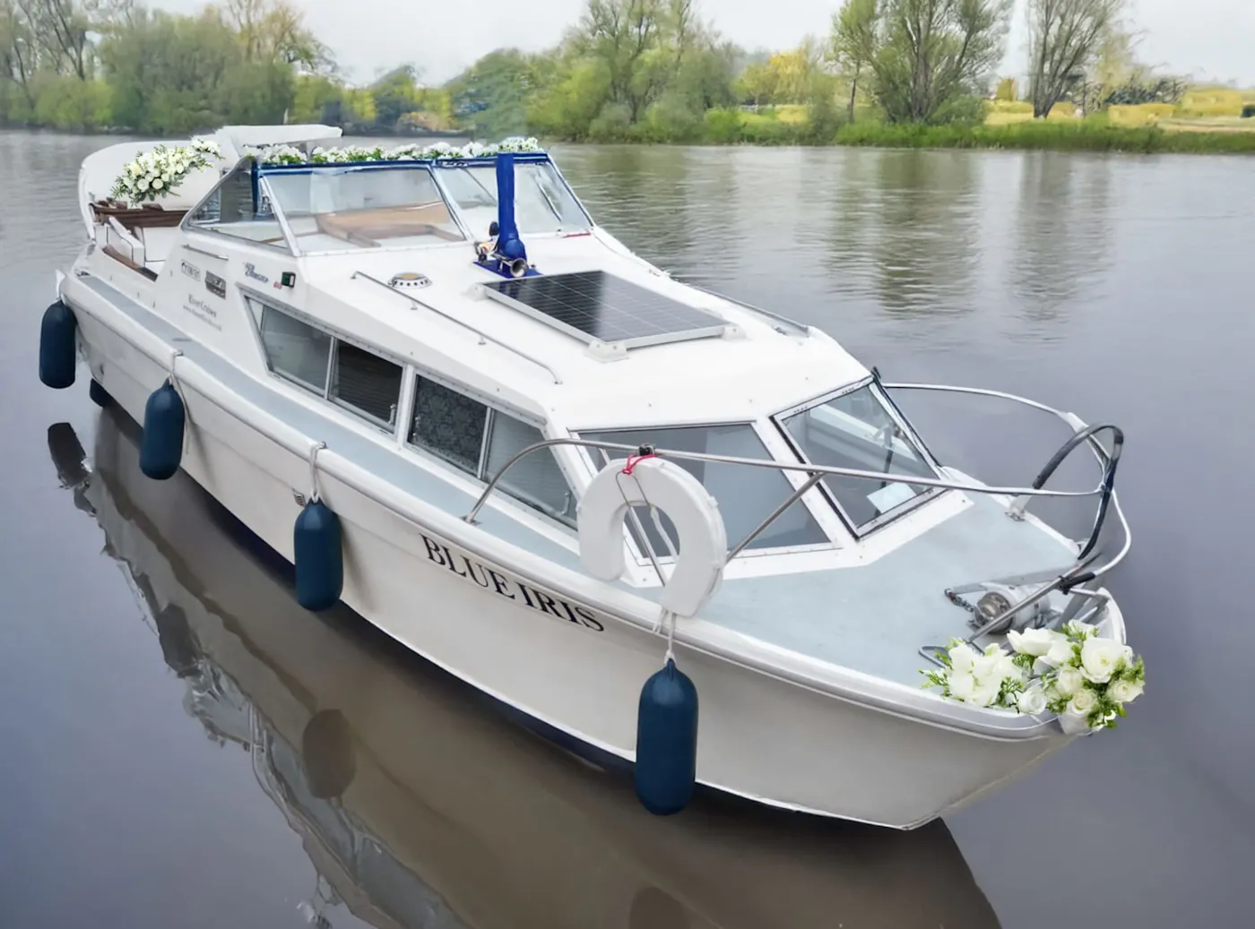The river cruiser Blue Iris decorated with white flowers on the River Avon