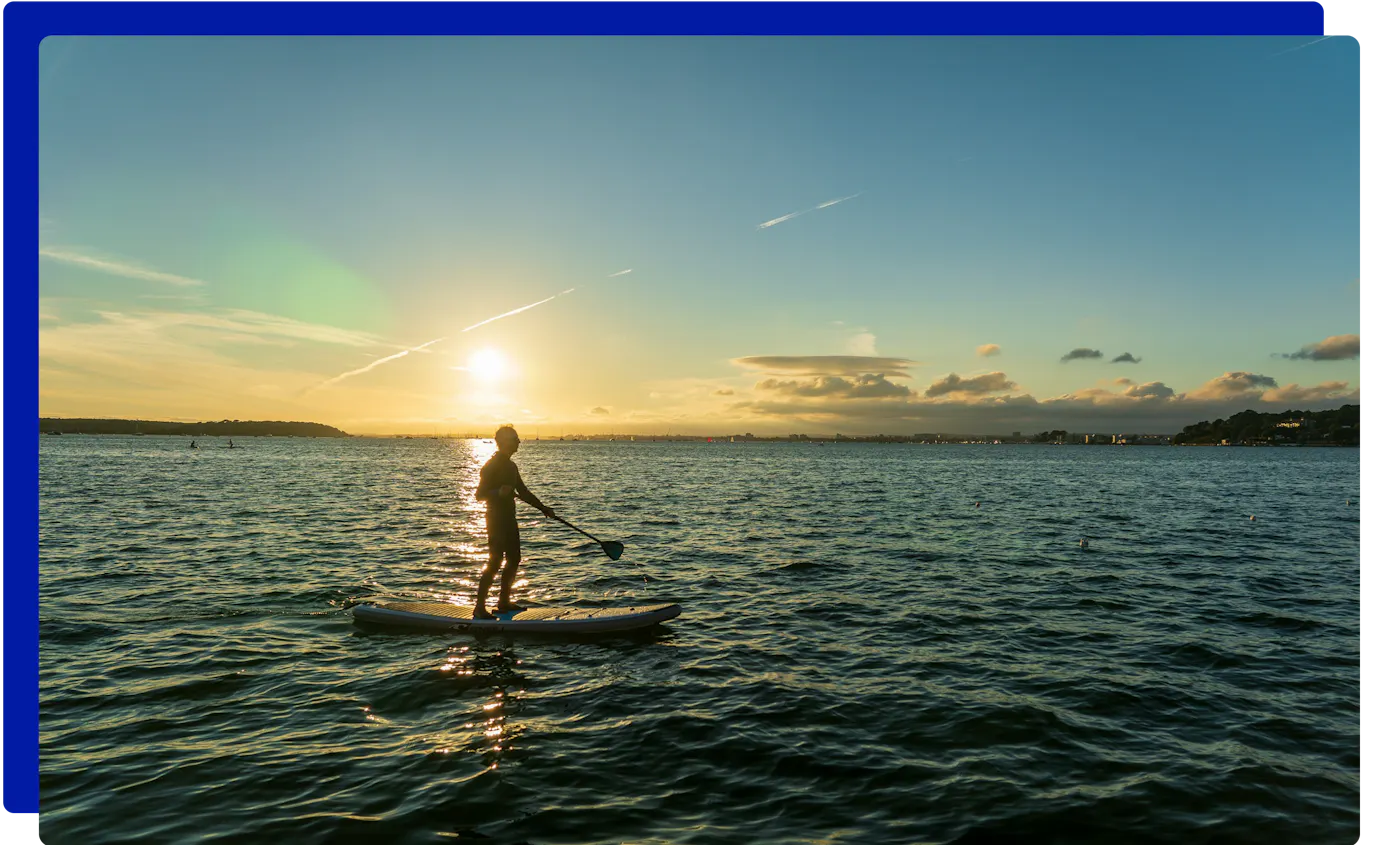 Paddleboarding at sunset at Sandbanks, Poole