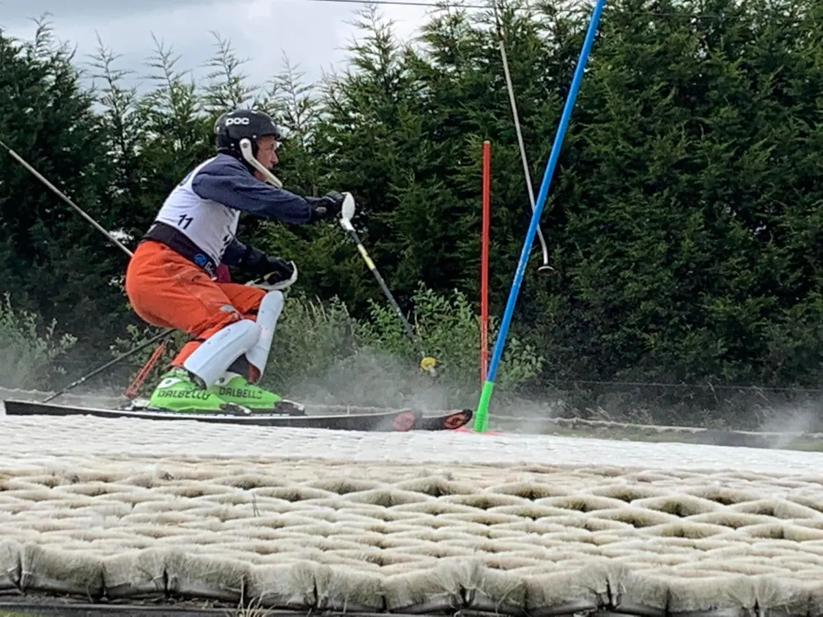 A racer skiing through slalom gates on the dry ski slope at Llandudno