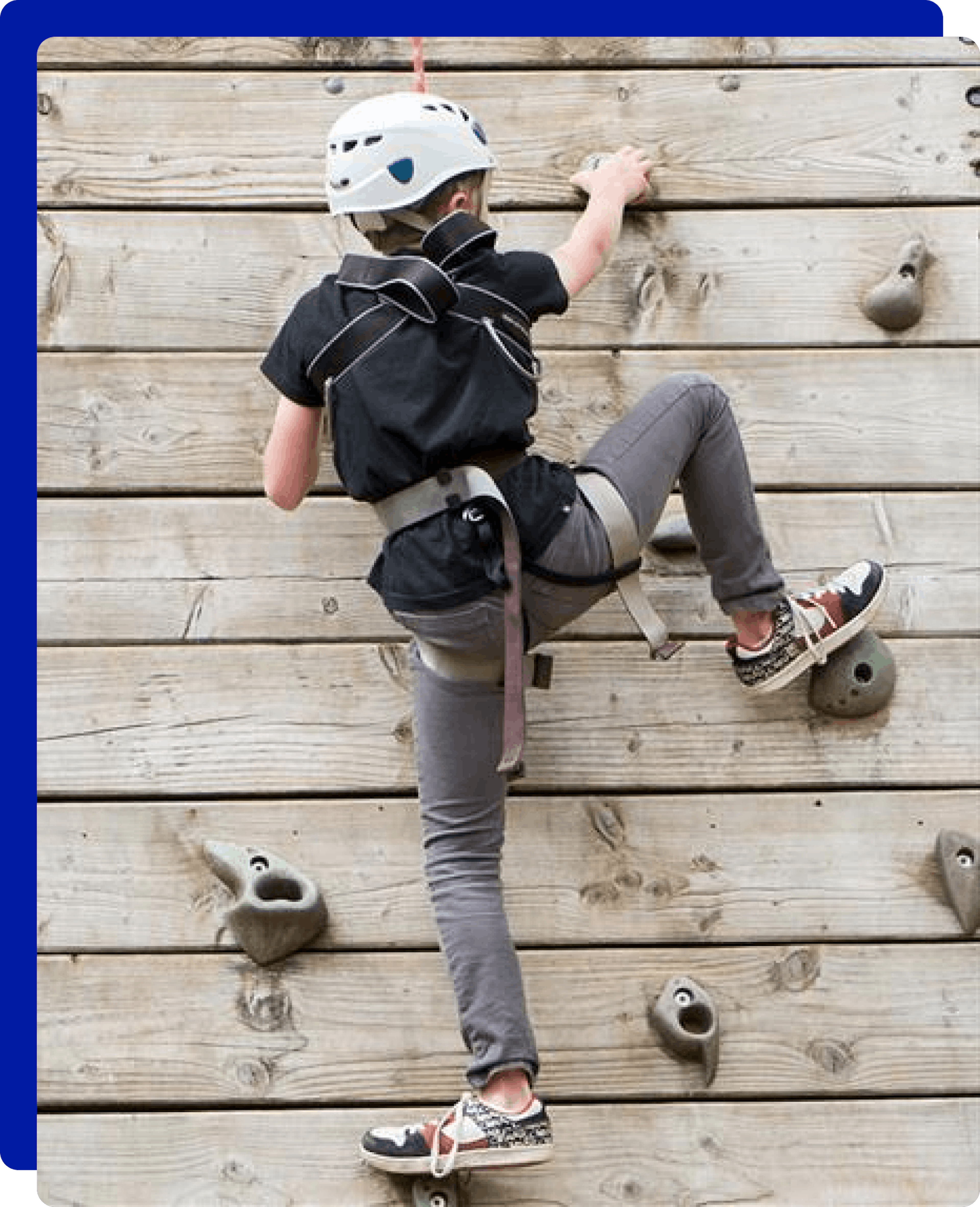 girl climbing a climbing wall