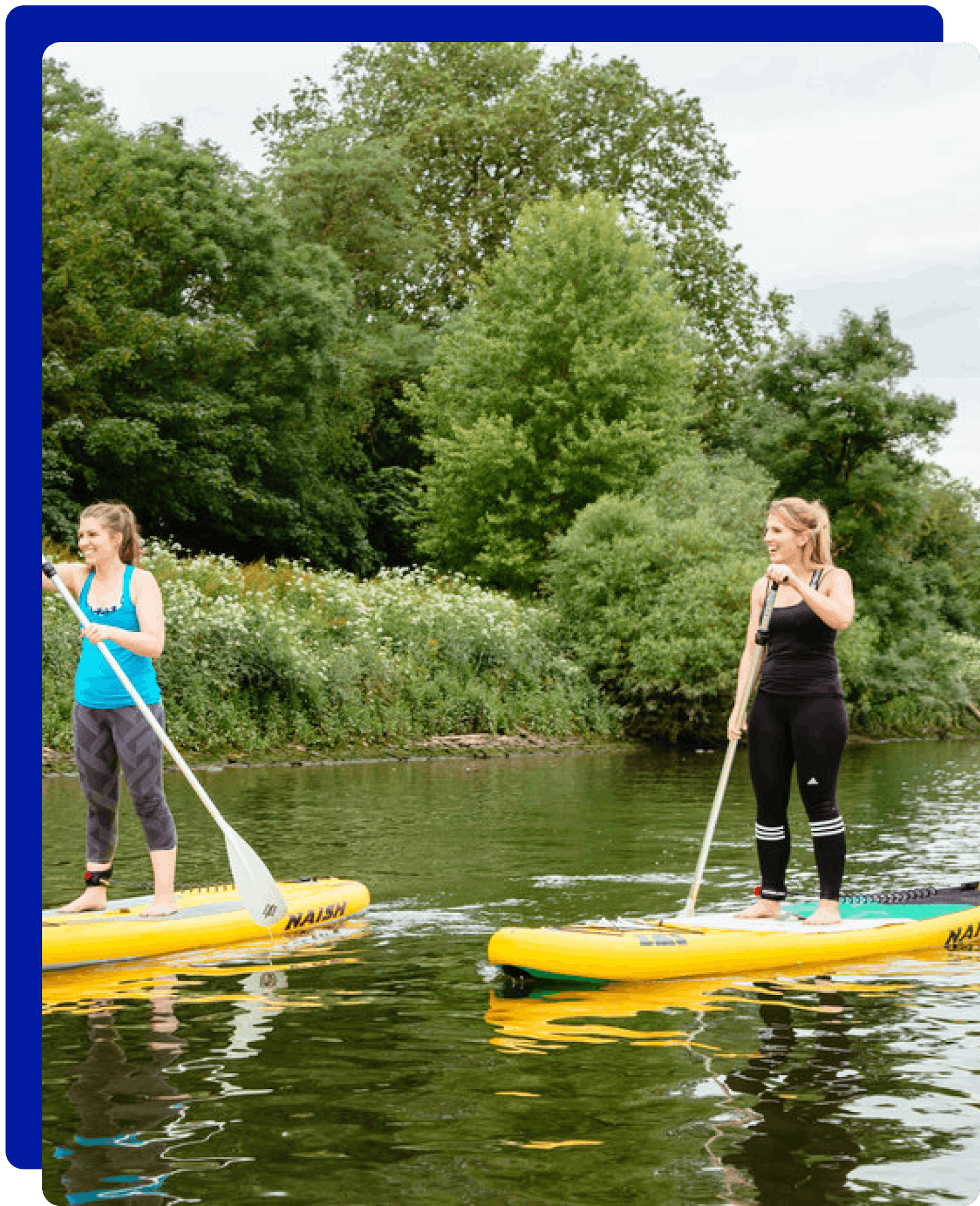 2 women paddleboarding in River Thames