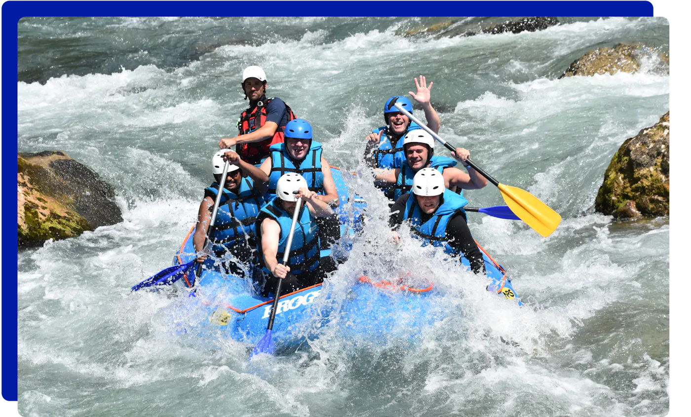 Group of people white water rafting with Frogs Rafting