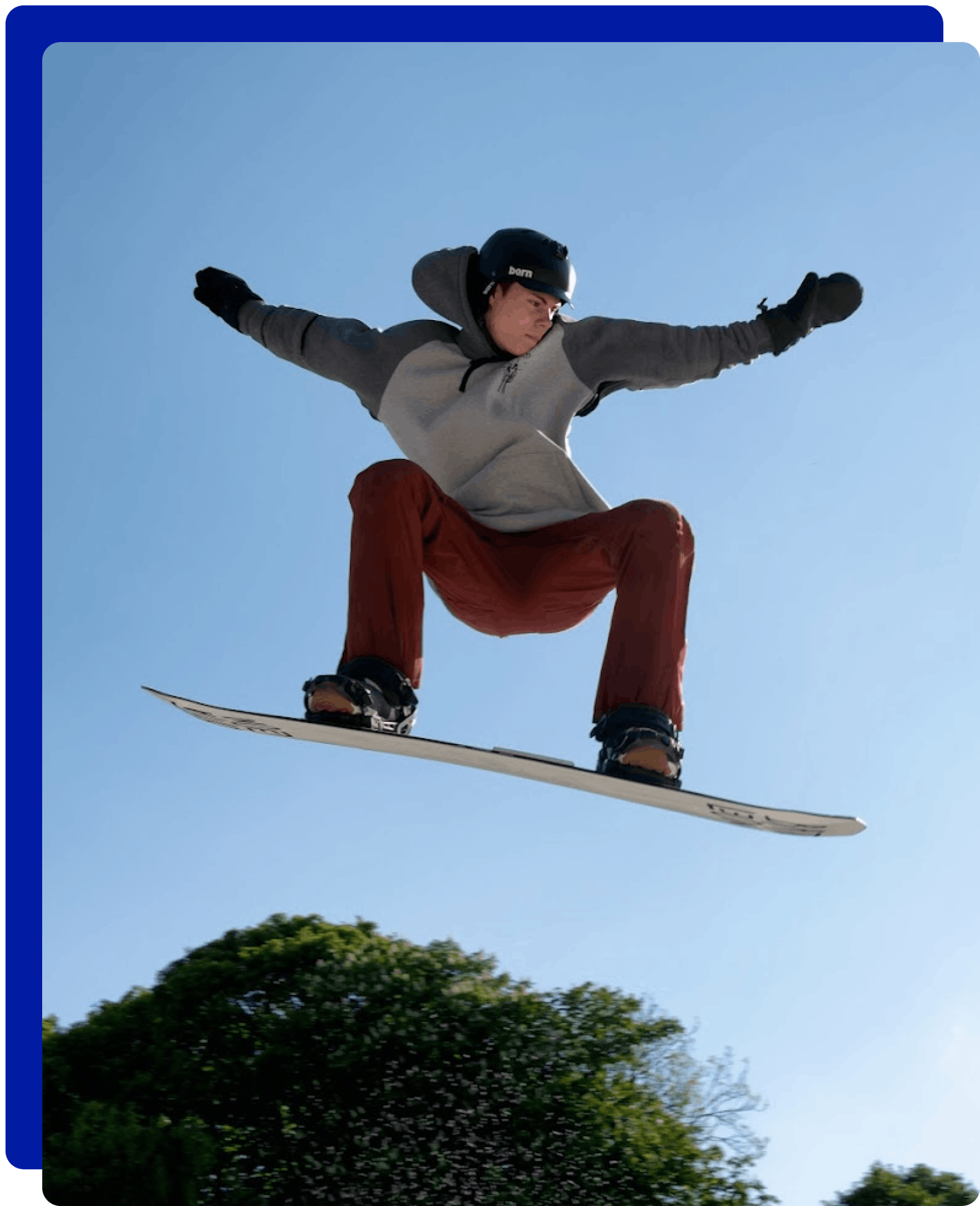 Man jumping while snowboarding at Norfolk Snowsports Club