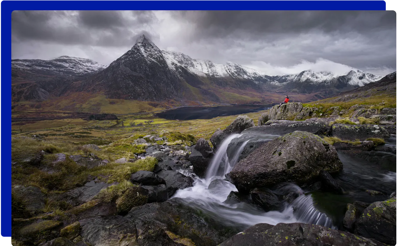 Hiker above a waterfall below Tryfan in Eryri (Snowdonia)