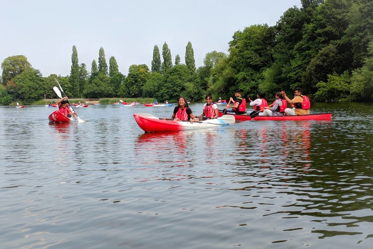 people kayaking on calm stream