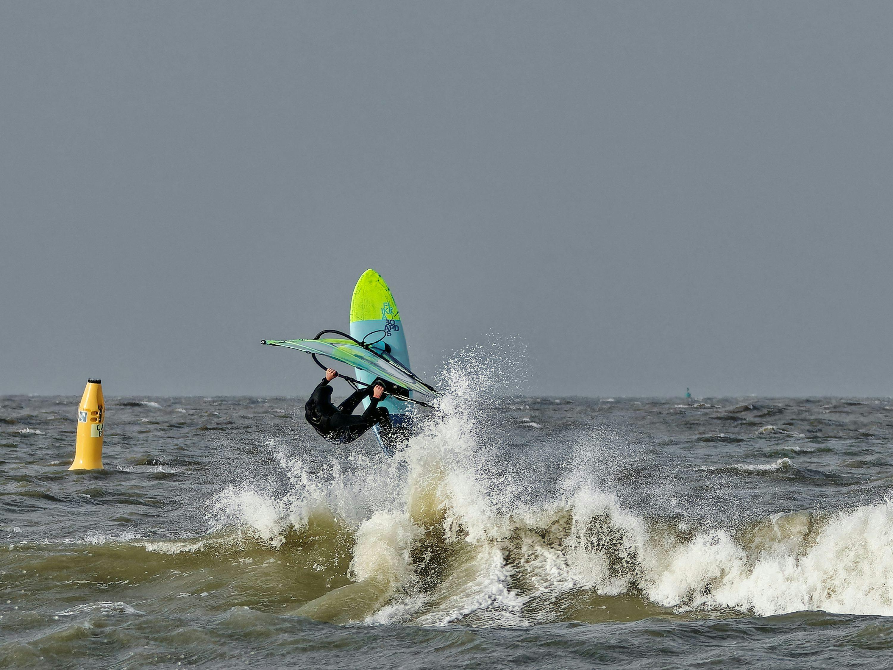 a person riding a surf board on top of a wave