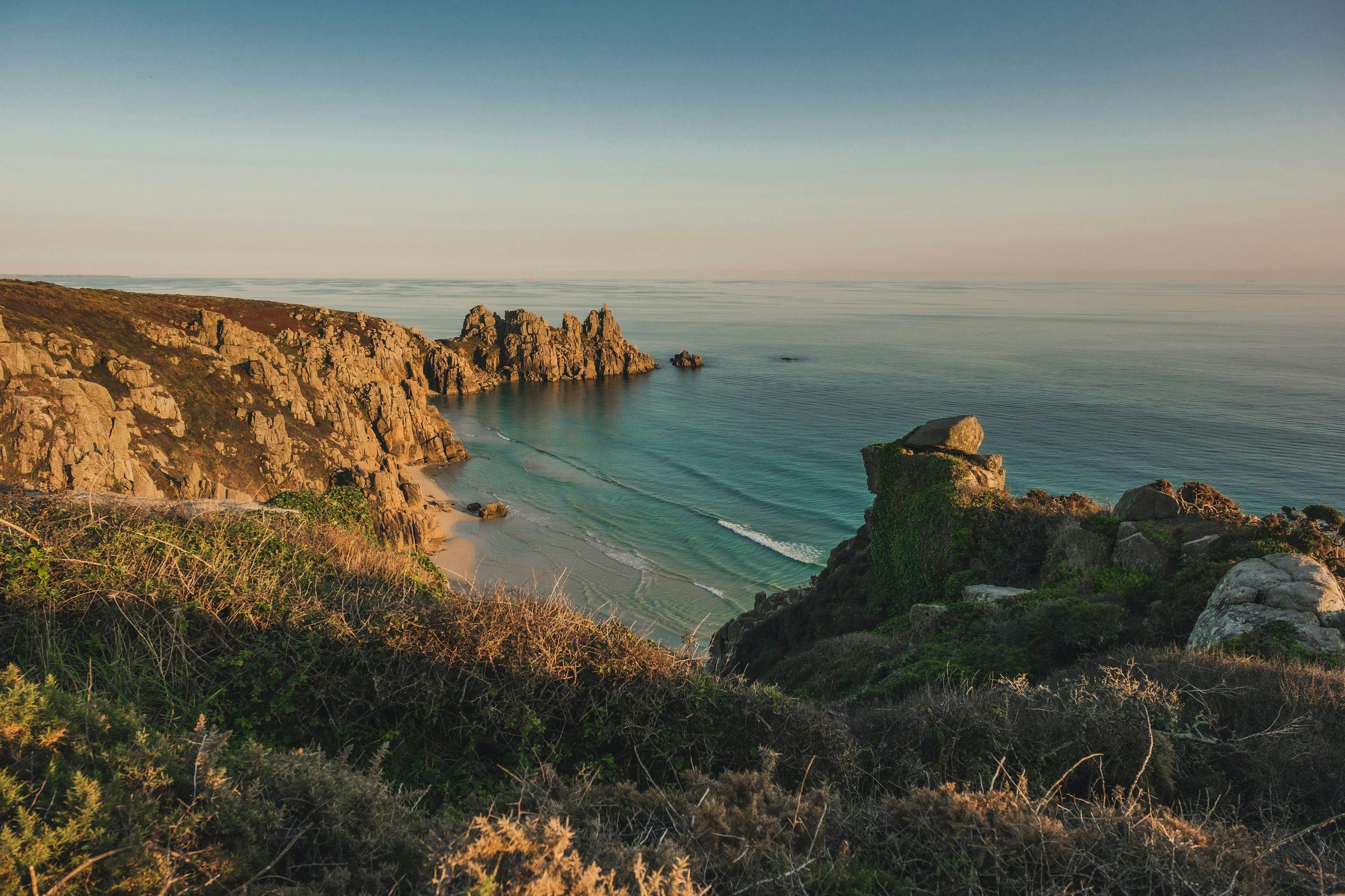 a view of the ocean from the top of a hill