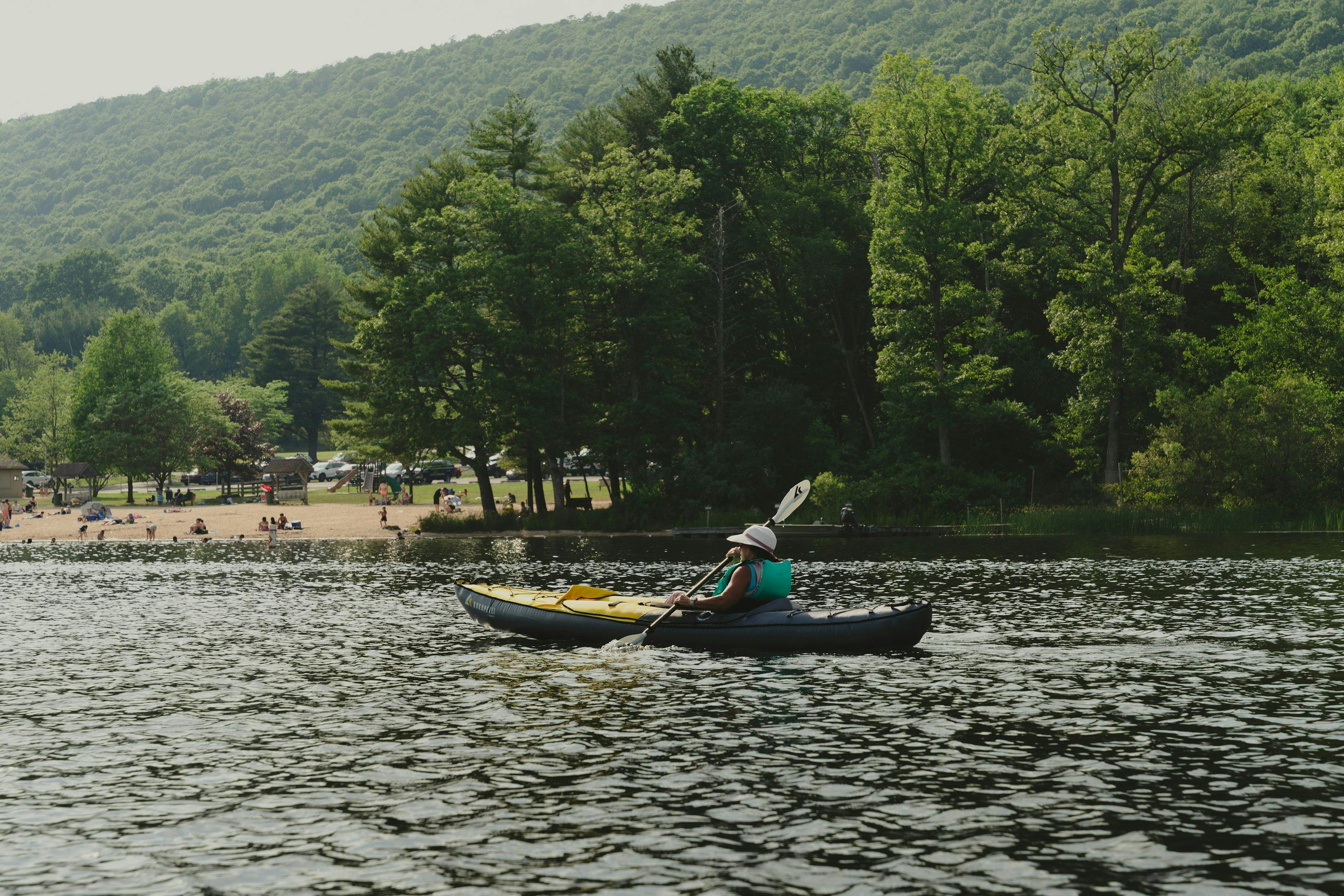 A person in a kayak paddling down a river