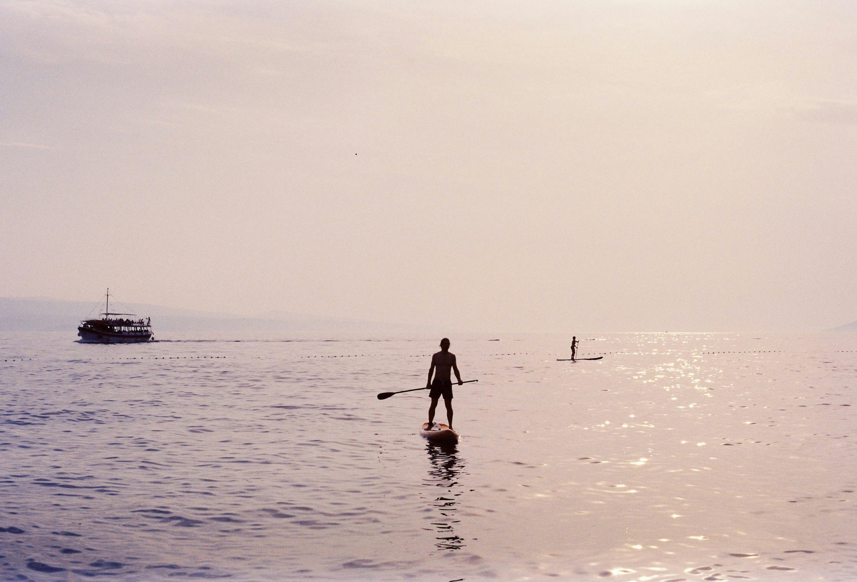 A man standing on a surfboard in the ocean