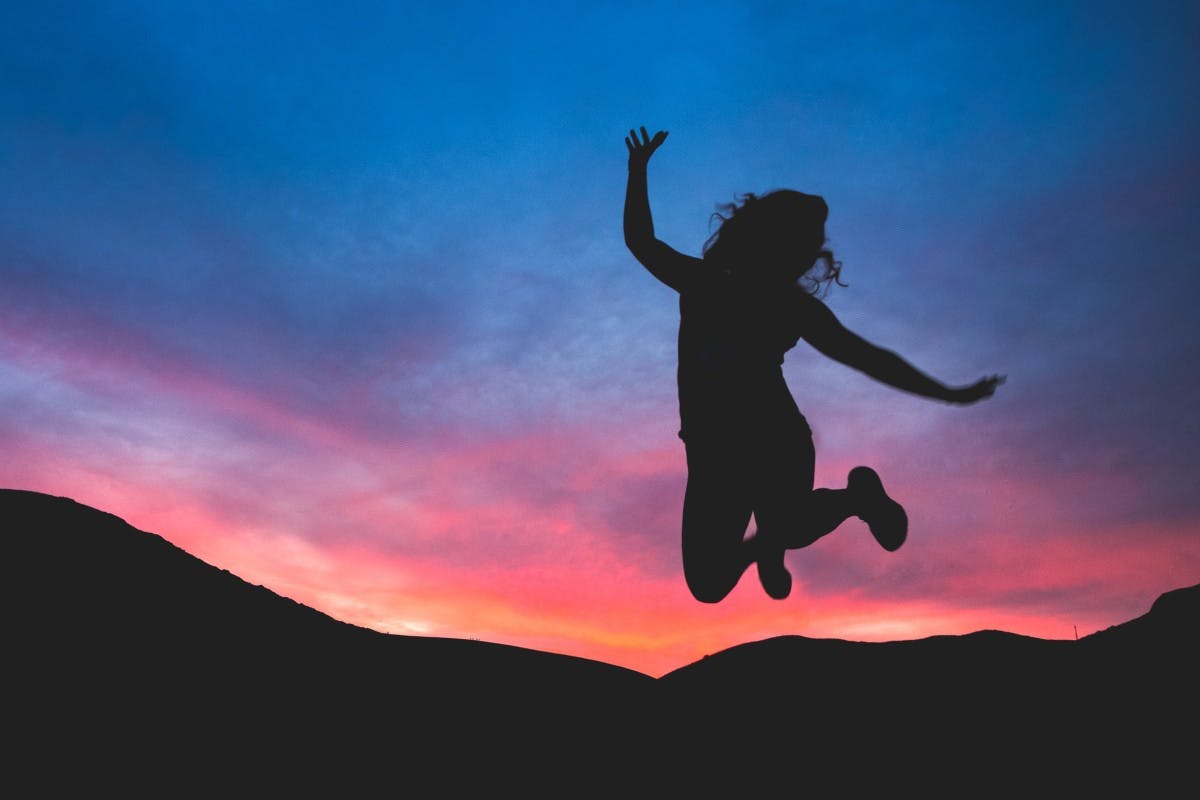 women jumping in happiness