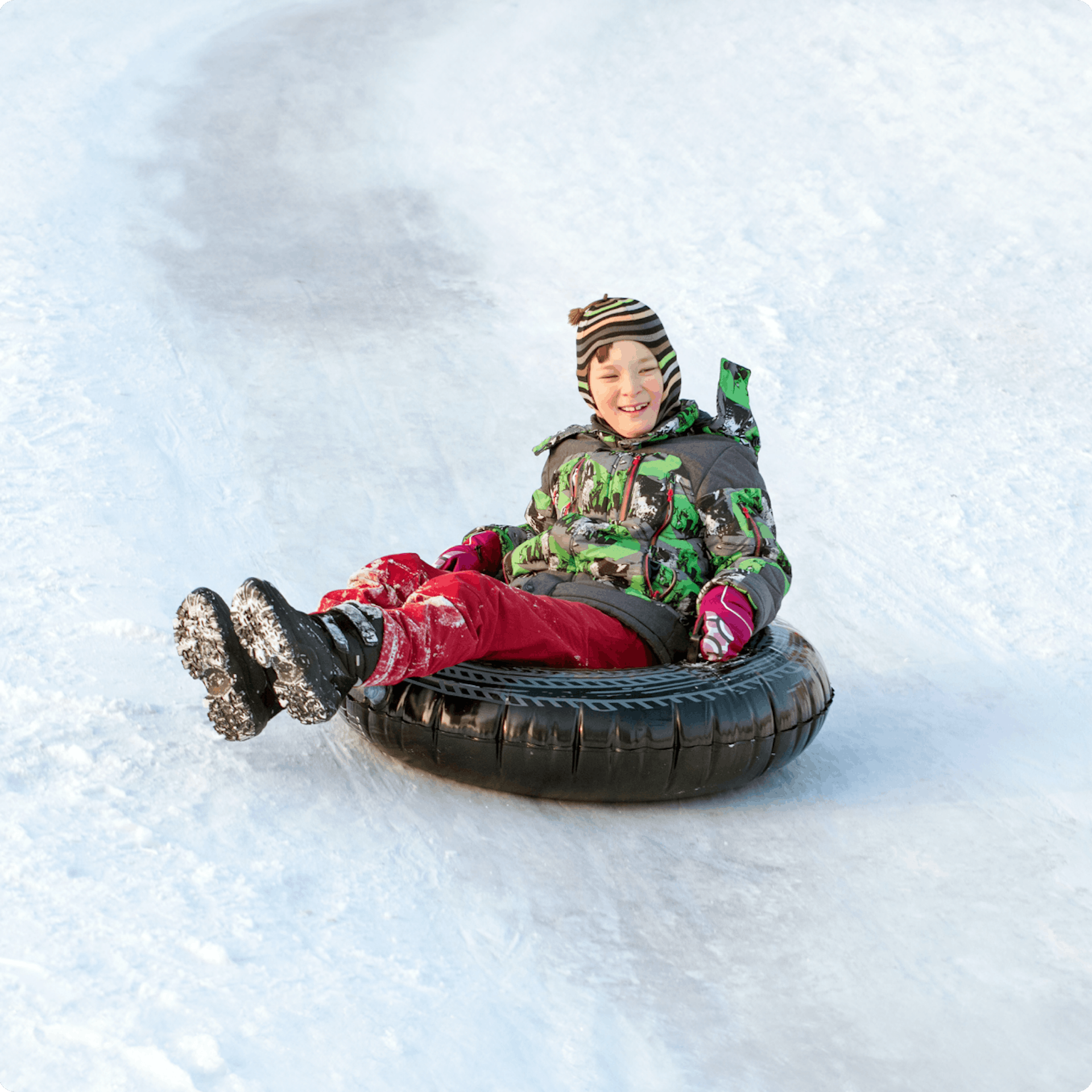 Child donutting in dry ski slope 