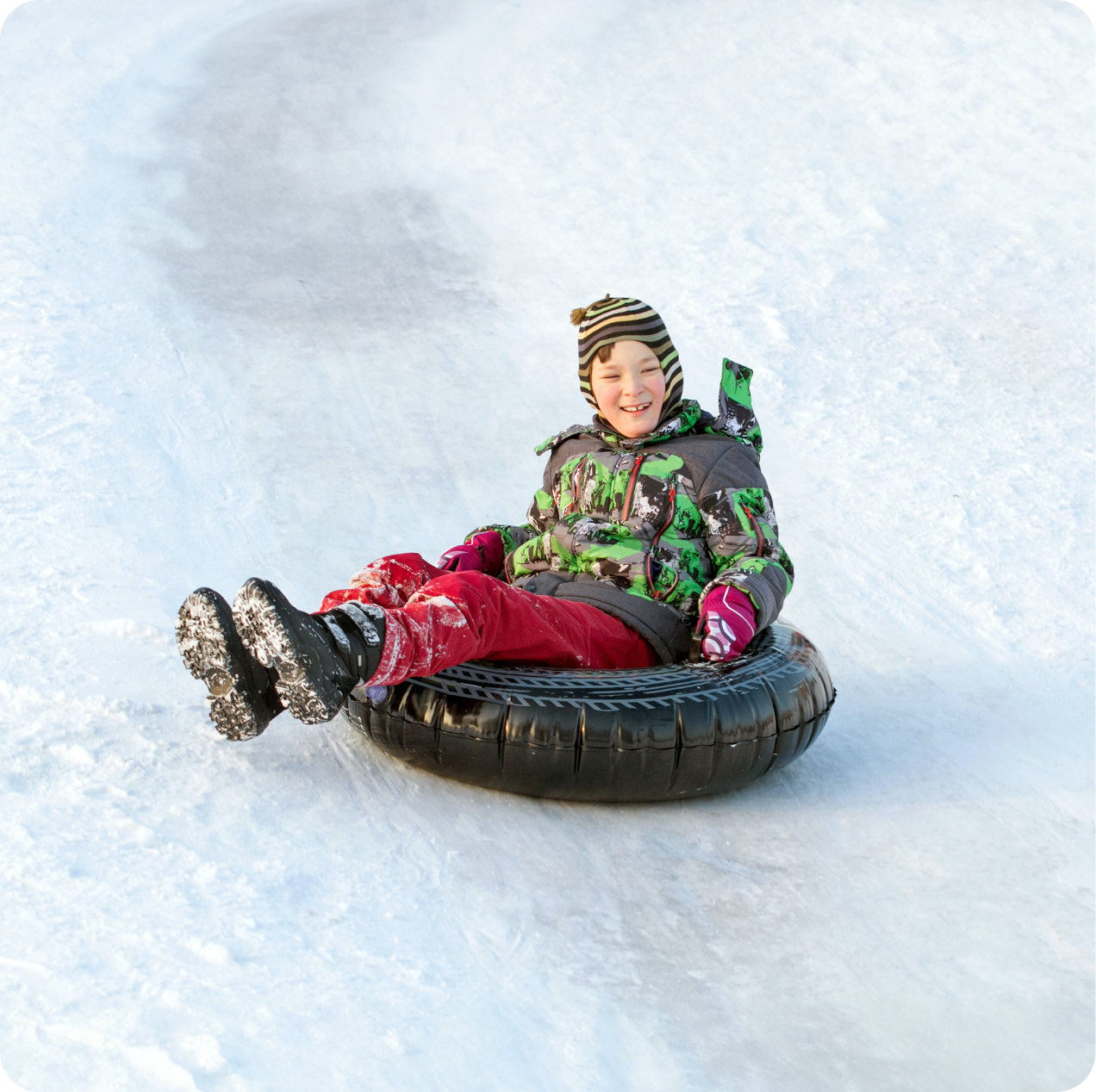 Child donutting on ski slope