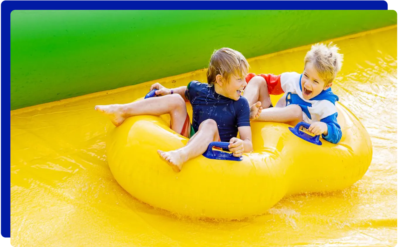 Children enjoying the Ultimate Slip n Slide in Somerset