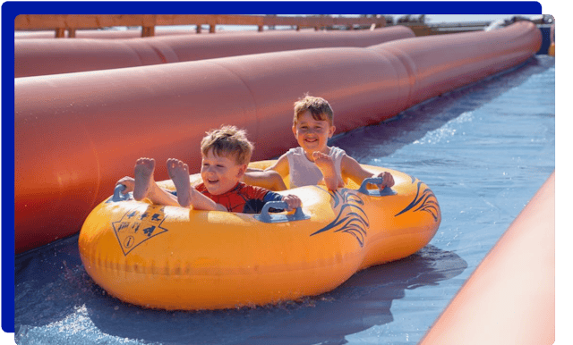 Children sliding down at Cornwall Slip and Slide in Newquay, Atlantic Reach Resort