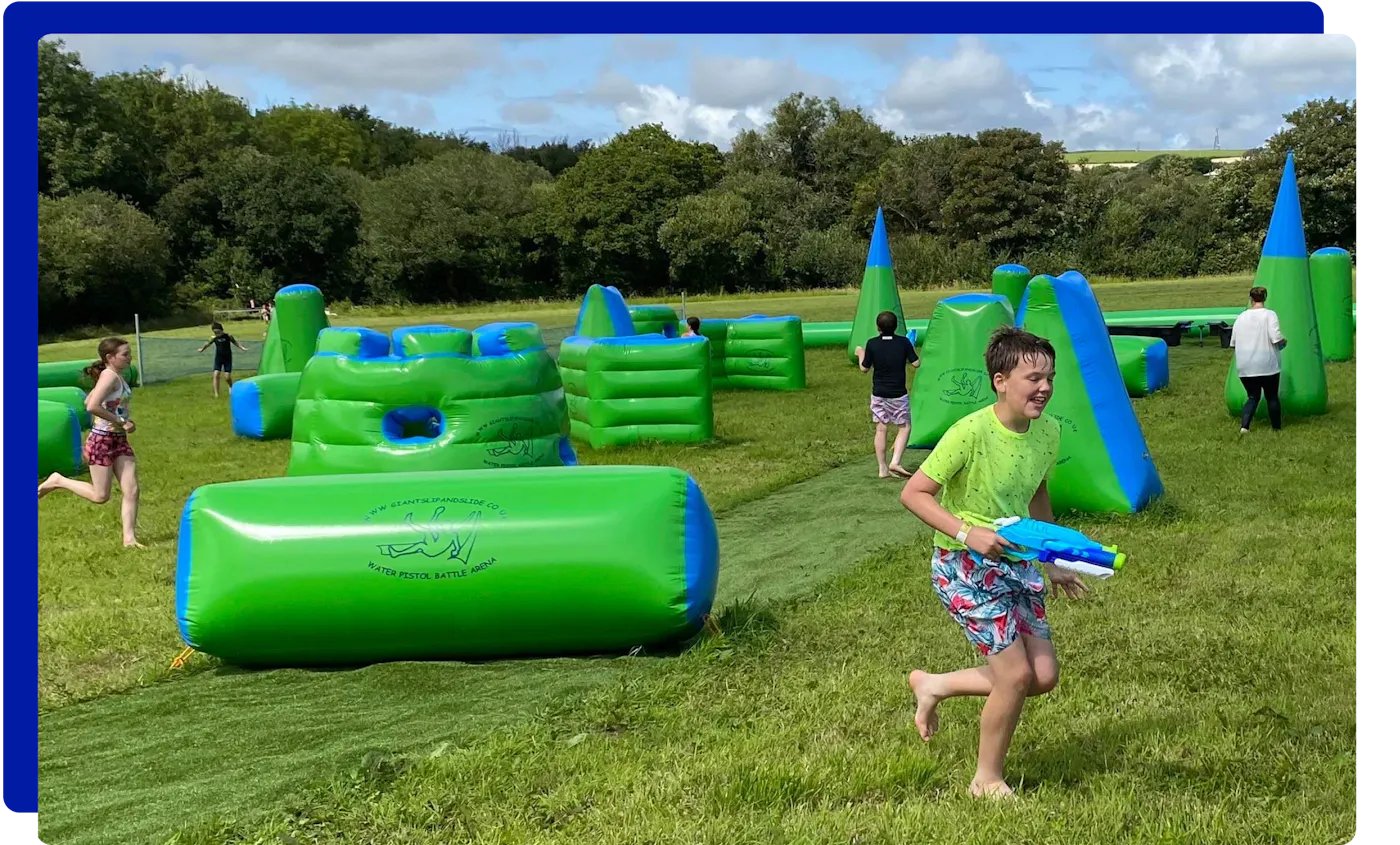 Children having fun at the water pistol battle park experience at Giant Slip and Slide Cornwall
