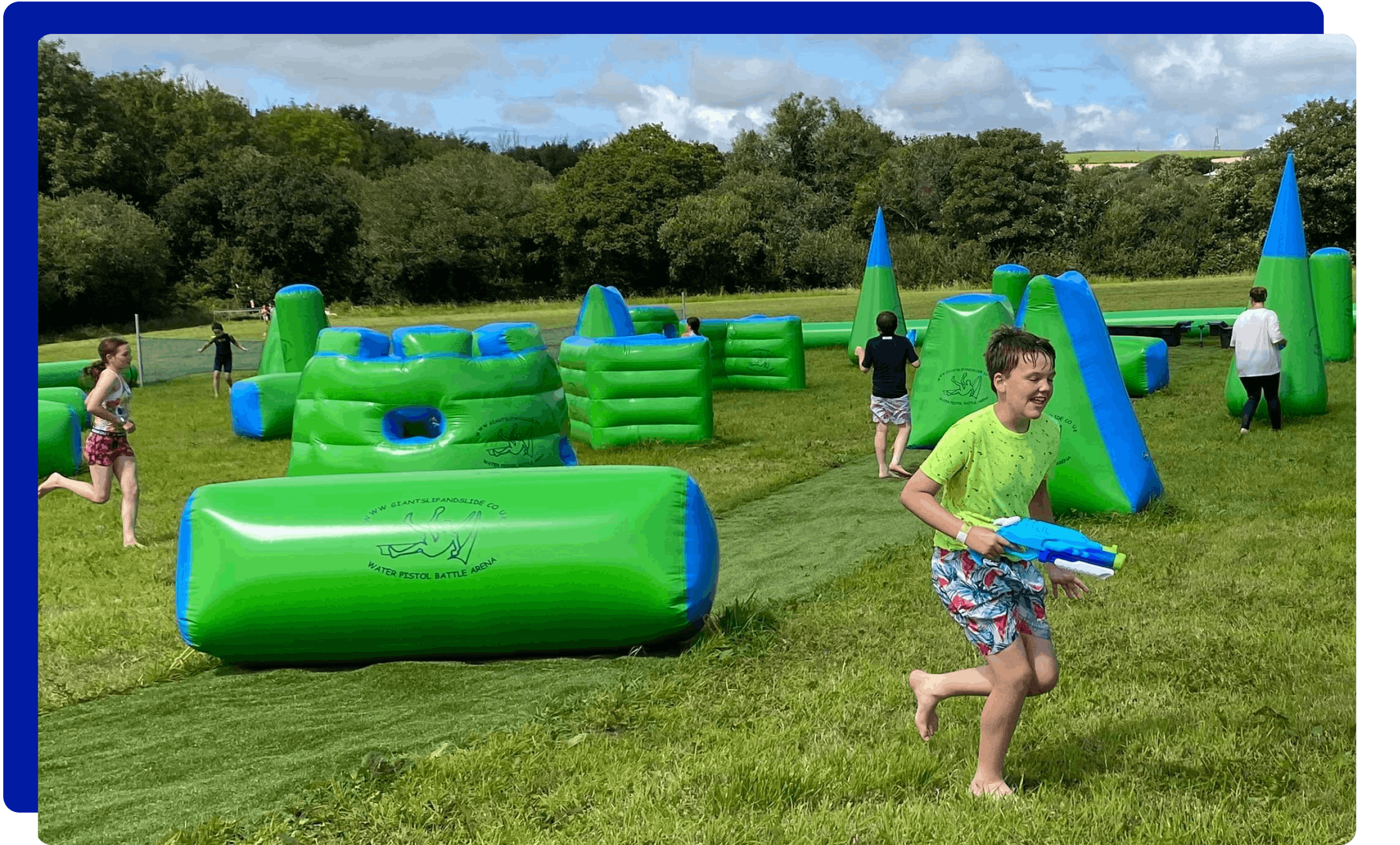 Children having fun at the water pistol battle park experience at Giant Slip and Slide Cornwall
